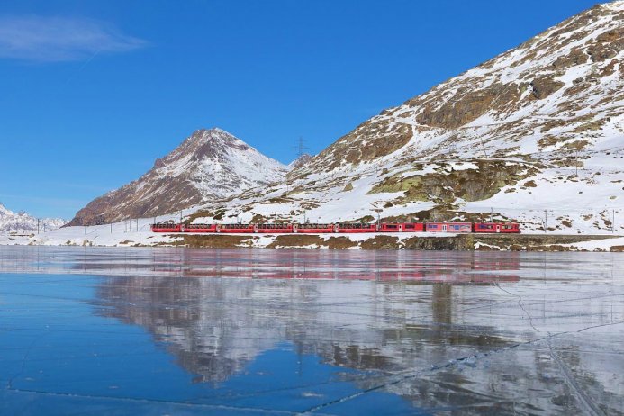 Train in front of a snowy mountain